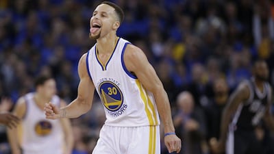 Golden State Warriors guard Stephen Curry reacts after a basket against the San Antonio Spurs on Monday night in his team's victory. Macio Jose Sanchez / AP / January 25, 2016