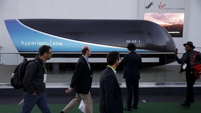 Attendees walk past a Virgin Hyperloop One XP-1 pod outside at the 2018 Consumer Electronics Show in Las Vegas, Nevada. Patrick T. Fallon / Bloomberg