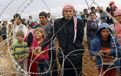 Syrian refugees wait at the Syrian-Turkish border as fears grow that one of the last remaining humanitarian aid crossing points will close. EPA