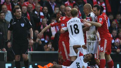 Nani of Manchester United lies on the pitch following a challenge by Jamie Carragher of Liverpool. Getty Images