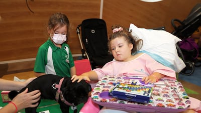 Left to right; Philppa Paul and Milou Paul meeting Millie the Pug during the arts and crafts session.