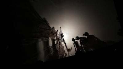 A puppet master also known as ‘Tok Dalang’ performs with a shadow puppet during the Malam Wayang (Night Shadow Puppet) event in Kuala Lumpur, Malaysia. Fazry Ismail / EPA