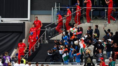 England's captain Alastair Cook, lower left, eventually led the team out for the presentation. Cook won the toss and predictably put India to bat as the muggy conditions would have aided his seamers. Sang Tan / AP Photo