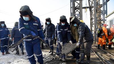 Rescuers clear debris from the site of an explosion that left more than 20 workers trapped in a gold mine in China's eastern Shandong province. AP