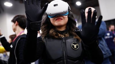 A person tries out bHaptic's wireless vest and gloves, which act as a wireless controller for virtual and augmented reality during the CES Unveiled Las Vegas exhibition at the 2023 International Consumer Electronics Show in Las Vegas, Nevada. EPA