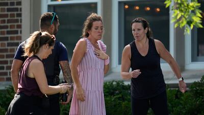 People arrive at the scene. AP