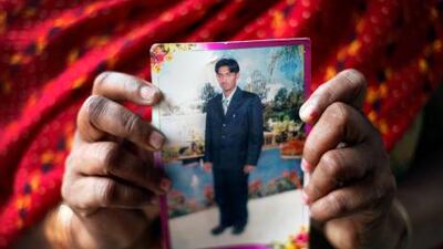 Veer Kaur holds a photograph of her son Sukhjinder Singh, who is one of 17 Indians sentenced to death by a court in Sharjah for killing a Pakistani man in January, 2009.