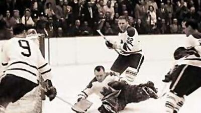 Johnny Bower, the Toronto Maple Leafs netminder, makes a stop against the Detroit Red Wings in the 1964 Stanley Cup finals.