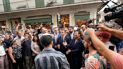 Mr Macron claps during a street band's performance on Royal St in the French Quarter of New Orleans alongside Mayor Latoya Cantrell. AP