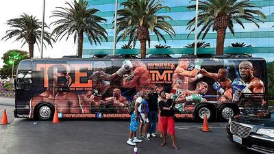 People take photos in front of a Mayweather Promotions bus parked in front of MGM Grand Hotel in Las Vegas. Ethan Miller / Getty Images