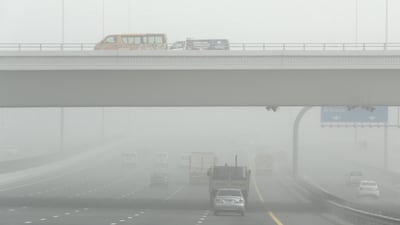 Traffic on Emirates Road in Dubai during the sandstorm. Pawan Singh / The National