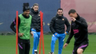 Barcelona's Spanish coach Xavi (2R) heads a training session at the Joan Gamper training ground in Sant Joan Despi on April 13, 2022 on the eve of the Europa League quarter final second leg football match between FC Barcelona and Eintracht Frankfurt. (Photo by Josep LAGO / AFP)