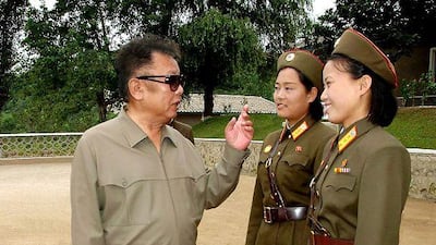In this undated photo, the North Korean leader Kim Jong Il chats with female soldiers.