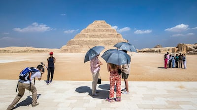 Visitors stand near the step pyramid of the third dynasty Ancient Egyptian Pharaoh Djoser (27th century BC) at the Saqqara Necropolis, south of Egypt's capital Cairo. AFP