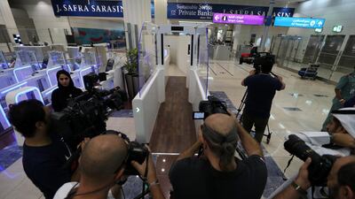 Members of the media and officials gather during the experimental launch of the smart tunnel project at Dubai International Airport. EPA