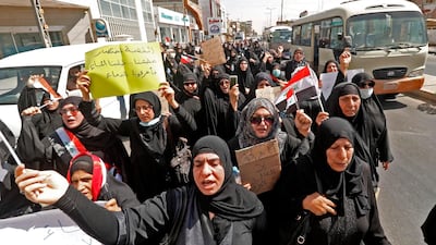 Iraqi women demonstrate against the government and the lack of basic services on September 7, 2018 in the southern city of Basra. - Iraq's parliament today called an emergency session after a curfew was imposed in the southern city of Basra following a fresh outbreak of deadly protests over poor public services and as shells were fired into Baghdad's fortified Green Zone. (Photo by Haidar MOHAMMED ALI / AFP)