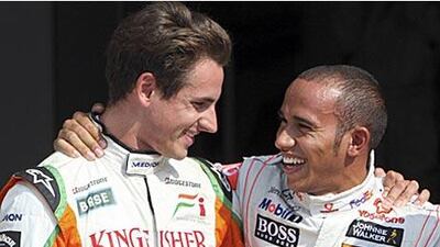 Lewis Hamilton, right, celebrates his surprise pole with Adrian Sutil who will line-up alongside him on the front row at Monza.