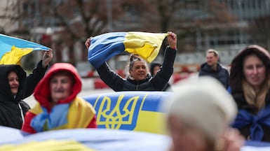 Protesters wave Ukrainian flags near the UN office in Geneva as peace talks between Russia and Ukraine take place. Reuters