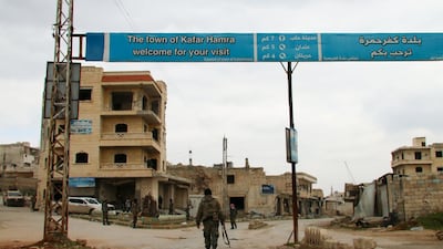 Syrian army soldiers walk in the town of Kafr Hamra in the northern Aleppo countryside. AFP
