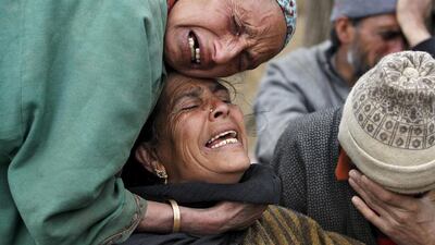 Relatives mourn during the funeral of the victims who died after a hillside collapsed onto a house in Ledhan village, west of Srinagar. Danish Ismail / Reuters