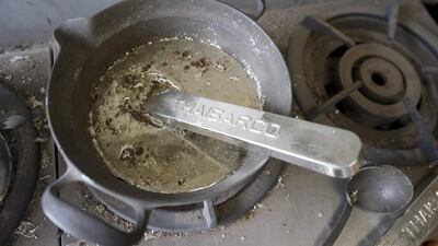 An ingot of tin imported from Thailand being melted at the Nousaka metal crafts factory in Takaoka. Everett Kennedy Brown / EPA