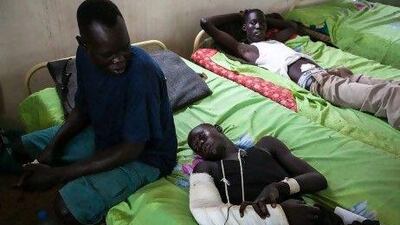 Sudan People's Liberation Army soldiers Chol Lang, 24, Bieth Keer, 22, and Majok Deng, 28, who were injured in a rebel ambush, rest inside a ward at a military hospital in Juba.