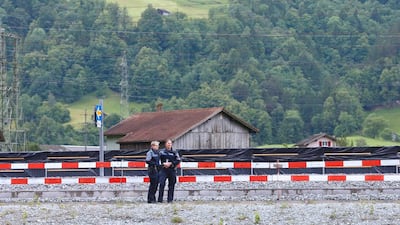 Swiss police officers stand on guard for the opening ceremony. Ruben Sprich / AFP