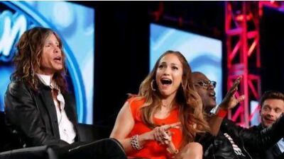 Jennifer Lopez, center, and fellow American Idol judges Steven Tyler, left, of Aerosmith, and Randy Jackson, along with Ryan Seacrest, far right. Danny Moloshok / AP Photo