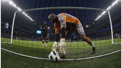 Ali al Habsi, the Wigan Athletic goalkeeper, collects the ball from the back of the net after fumbling David Silva's shot on Saturday. Jon Super / AP Photo