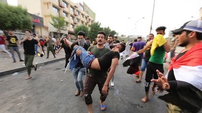 Iraqi protesters carry away a wounded man. EPA