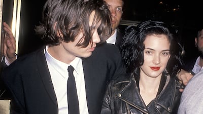 Winona Ryder, accompanied by Johnny Depp, wears a leather biker jacket to the 1990 Nato/ShoWest Convention on February 8, 1990 at Bally's Hotel and Casino in Las Vegas, Nevada. Getty