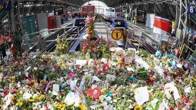 TA picture taken on August 5, 2019 at Frankfurt am Main's central stration shows flowers that people left to pay tribute to an eight-year-old boy who died after he was pushed under a train a week earlier. The horrific crime has dominated newspaper front-pages and TV news bulletins, and led politicians to call for heightened security, more camera surveillance and tighter border controls. AFP