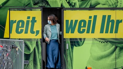 Annalena Baerbock leaves the Greens' campaign bus during an event in Mainz. Photo: AP