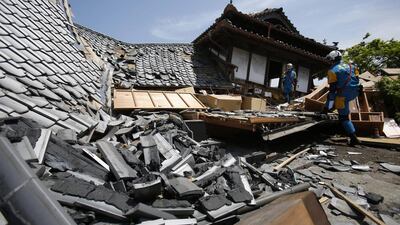 Police rescuers search through damaged houses to check for trapped people in Mashiki, southern Japan, on April 15, 2016. Koji Ueda/AP Photo