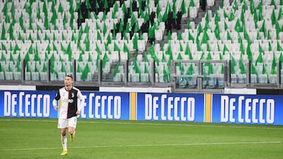 Ronaldo runs on the pitch in an empty stadium. AFP