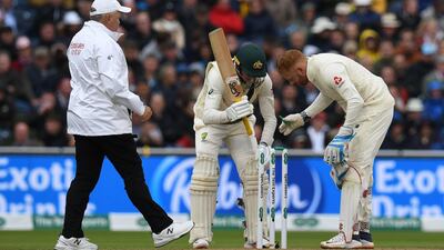 Umpire Marais Erasmus, Australia's Steve Smith and England's Jonny Bairstow check the bails during windy conditions. AFP