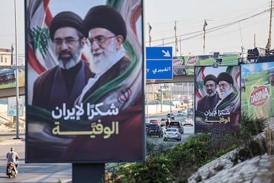 Billboards showing Iran’s Supreme Leader Mojtaba Khamenei and his late father, Ali Khamenei with the slogan 'Thank you, loyal Iran,' near the airport in Beirut. AFP