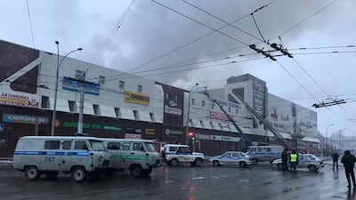 Rescue personnel is seen on a site of fire at a shopping mall in Kemerovo, Russia. Dmitry Saturin / Reuters