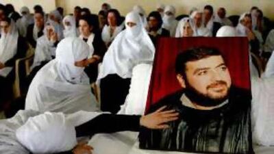 Family members and friends mourn next to the body of Lebanese Druze opposition politician Sheikh Saleh al Adidi.