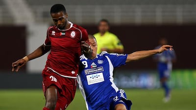 Eisa Ahmed, left, of Al Wahda tackles Takayuki Morimoto of Al Nasr during their match at the Al Nahyan Stadium in Abu Dhabi on April 14, 2013. Satish Kumar / The National