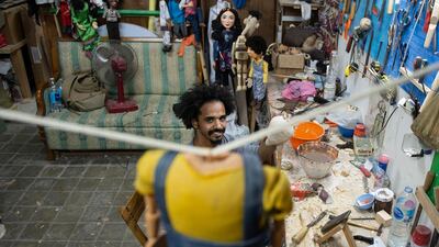 Mohamed Fawzy Bakkar poses for a picture in his workshop in Cairo, Egypt. EPA