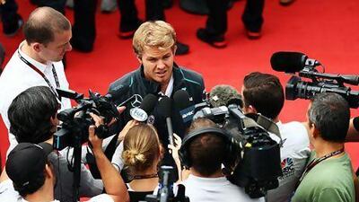 Mercedes GP’s German driver Nico Rosberg is mobbed by members of the media yesterday.