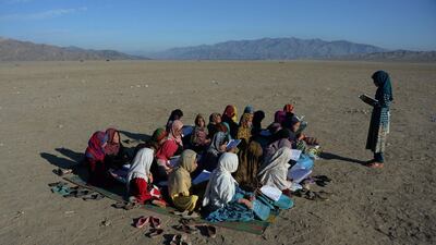 Afghan school children take part in a lesson at an open-air school at the Gambiri Refugee Camp in Laghman province. Noorullah Shirzada / AFP Photo