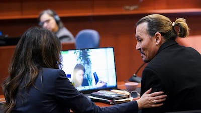 Depp speaks with Ms Vasquez. AP