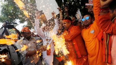 BJP supporters celebrate in New Delhi after learning the initial election results on May 23, 2019. Reuters