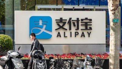 A man walks by an Alipay office building at Pudong Finance Plaza in Shanghai, China. The company has been credited with helping curb Covid-19 since it erupted in Wuhan. Getty Images