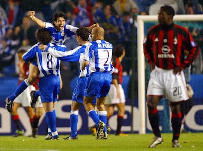 Deportivo players celebrate as Clarence Seedorf, right, looks on at Riazor Stadium in 2004. Miguel Riopa / AFP
