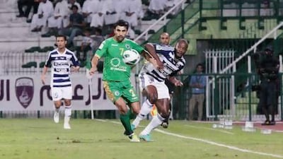 Dubai, United Arab Emirates - November 8, 2012. Jires Kembo-Ekoko ( no 9 of Al Ain ) against Haydarov Azizbek ( no 7 of Al Shabab) at the ongoing Etisalat Pro League. ( Jeffrey E Biteng / The National )