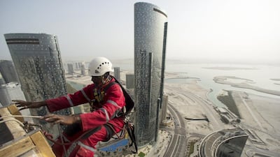 On the ropes, each climber will have about 20 litres of soapy water with them, plus their bucket, sponge and squeegee. Christopher Pike / The National