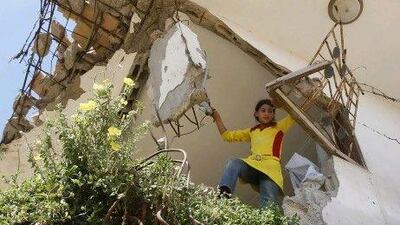 Palestinian girl Malak Al Louh stands inside the remains of her family's house, damaged during Israel's January 2009 offensive in Beit Lahiya in the northern Gaza Strip. Doha is to spend at least US$450 million on building roads, bridges and thousands of homes in Gaza.